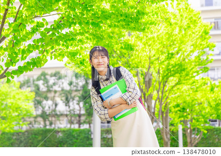 Female college student walking on campus Female college student walking on campus 138478010