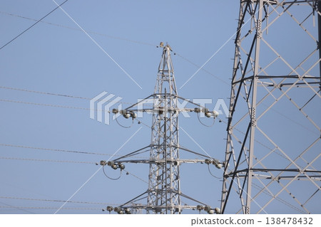 A crow perched on a steel tower A crow perched on a steel tower 138478432