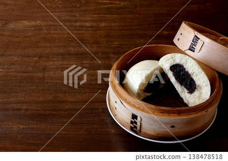 Sesame paste buns in a steamer basket in the background of the table Sesame paste buns in a steamer basket in the background of the table 138478518