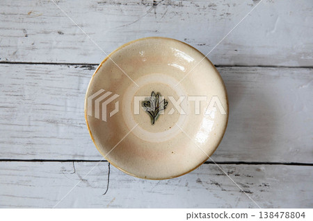 Okinawan pottery placed on a natural white wood surface. Okinawan pottery placed on a natural white wood surface. 138478804