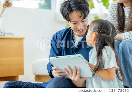 一家人在客廳看平板電腦 138478983