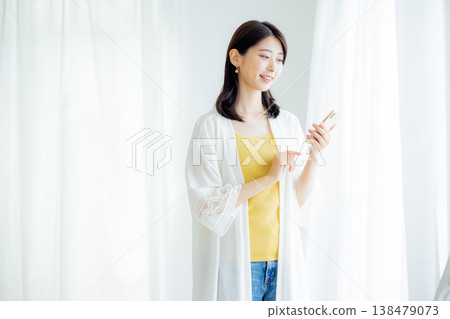 A young woman looking at a smartphone at home A young woman looking at a smartphone at home 138479073