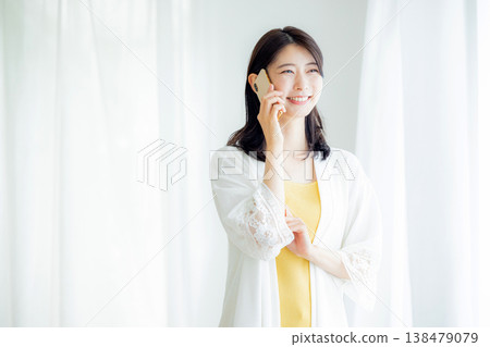 A woman talking on a smartphone 138479079