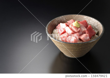 A bowl of diced tuna photographed alone against a black background. A bowl of diced tuna photographed alone against a black background. 138479421