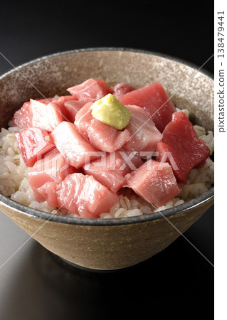 A bowl of diced tuna photographed alone against a black background. A bowl of diced tuna photographed alone against a black background. 138479441