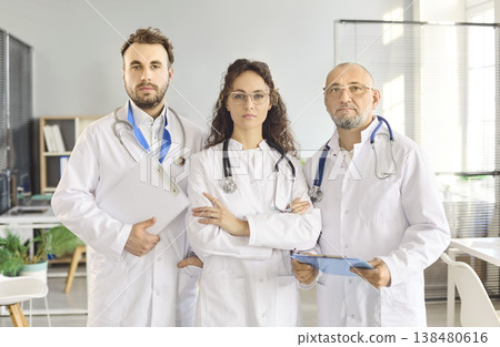 Confident medical team of doctors with stethoscopes in modern clinic office portrait 138480616