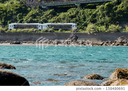 The limited express train "Umisachi Yamasachi" runs along the Iso coast in Sanno, Nichinan City, Miyazaki Prefecture. The limited express train "Umisachi Yamasachi" runs along the Iso coast in Sanno, Nichinan City, Miyazaki Prefecture. 138480691