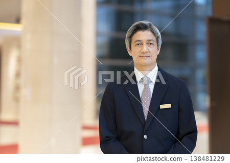A portrait of a businessman in his 60s smiling and looking directly at the camera. A portrait of a businessman in his 60s smiling and looking directly at the camera. 138481229