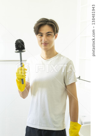Young teen boy cleaning bathroom at home. 138481943