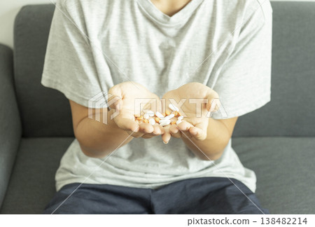 Teen boy have many pills in his hands.. Takes medication for illness Teen boy have many pills in his hands.. Takes medication for illness 138482214