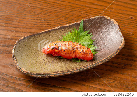 Grilled mentaiko (spicy cod roe): A popular snack grilled to perfection. Grilled mentaiko (spicy cod roe): A popular snack grilled to perfection. 138482240