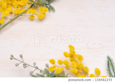 Close-up of mimosa flowers against a wood grain background. Close-up of mimosa flowers against a wood grain background. 138482255