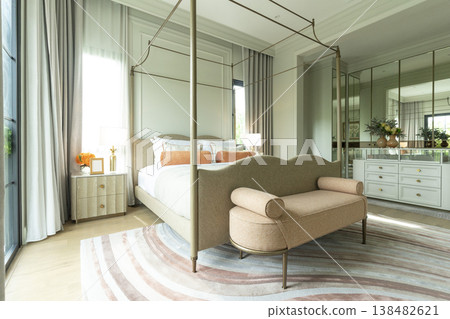 Interior view of King Size Canopy Bed Frame with pillows in elegant bedroom. Honeymoon suite bedroom in pastel and pink color Interior view of King Size Canopy Bed Frame with pillows in elegant bedroom. Honeymoon suite bedroom in pastel and pink color 138482621