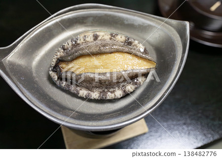 Fresh, live abalone grilled right in front of you. Fresh, live abalone grilled right in front of you. 138482776
