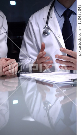 Doctor consulting patient, discussing diagnosis and prescription, providing medical advice during healthcare appointment, practitioner writing down notes Doctor consulting patient, discussing diagnosis and prescription, providing medical advice during healthcare appointment, practitioner writing down notes 138483842