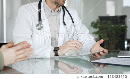 Doctor man discussing medical information with patient woman using digital tablet during consultation, healthcare technology concept. Medicine, health care and science concept 138483850
