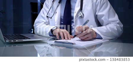 Doctor or health professional managing patient data, documenting information, and utilizing digital technology for medical records and administrative tasks in a clinic or office setting 138483853