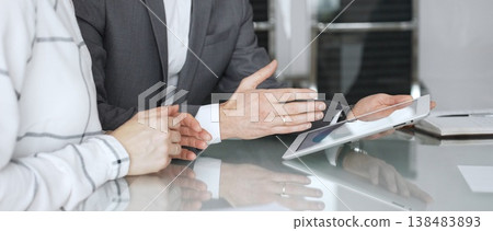 Business people hands discussing data on digital tablet during an office meeting, planning strategy and analyzing results Business people hands discussing data on digital tablet during an office meeting, planning strategy and analyzing results 138483893