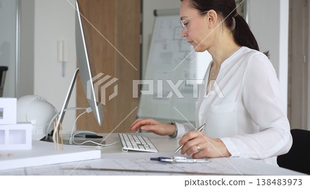 Architect woman planning future building design on computer in office, a professional engineer developing urban construction project. Business and architecture concept 138483973
