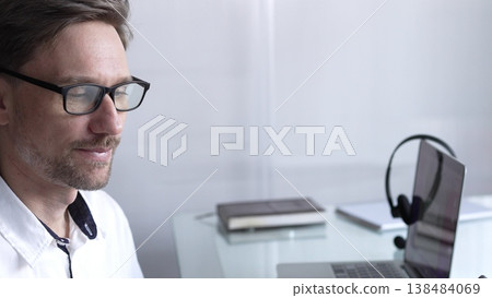 Businessman office worker attending online meeting using laptop and microphone, working remotely from home or office. Businesspeople concept Businessman office worker attending online meeting using laptop and microphone, working remotely from home or office. Businesspeople concept 138484069