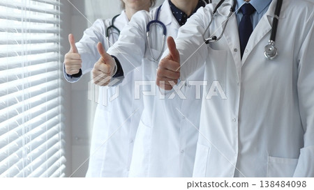 Medical team showing thumbs up gestures, symbolizing healthcare success, collaboration, good results, excellent medical service, and professional doctor approval Medical team showing thumbs up gestures, symbolizing healthcare success, collaboration, good results, excellent medical service, and professional doctor approval 138484098