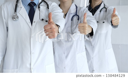 Doctor team showing thumbs up, symbolizing healthcare success, medical approval, achieving goals, quality patient care, positive health outcomes, and professional support Doctor team showing thumbs up, symbolizing healthcare success, medical approval, achieving goals, quality patient care, positive health outcomes, and professional support 138484129