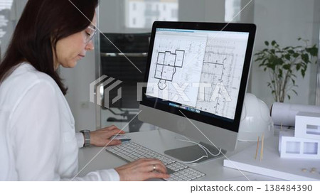 Woman architect drawing building plans on computer, designing modern housing project with cad software. Business and architecture concept 138484390