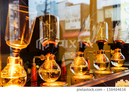 專業職人於精品咖啡廳使用虹吸式咖啡壺沖煮咖啡的優雅過程特寫 專業職人於精品咖啡廳使用虹吸式咖啡壺沖煮咖啡的優雅過程特寫 138484616