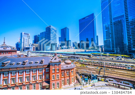 A spectacular view of Tokyo's cityscape, including the auspicious Shinkansen "Doctor Yellow," Tokyo Station, trains, and the skyscrapers of Yaesu. 138484784