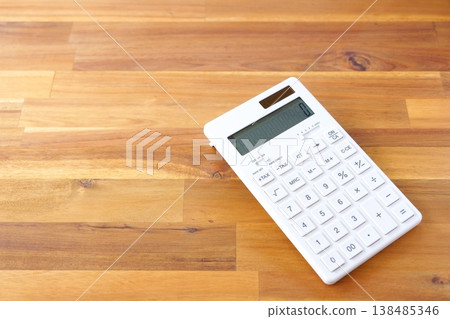 Calculator - A white calculator on a table Calculator - A white calculator on a table 138485346