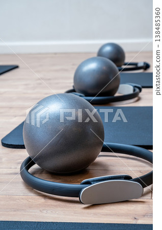 Essential pilates equipment for mat practice including yoga mat, pilates ring, resistance bands and fitness ball. Essential pilates equipment for mat practice including yoga mat, pilates ring, resistance bands and fitness ball. 138485360
