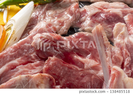 A cooking scene of grilling lamb and vegetables in a Genghis Khan hot pot. Genghis Khan, a famous Hokkaido dish, is a lamb BBQ gourmet meal. A cooking scene of grilling lamb and vegetables in a Genghis Khan hot pot. Genghis Khan, a famous Hokkaido dish, is a lamb BBQ gourmet meal. 138485518