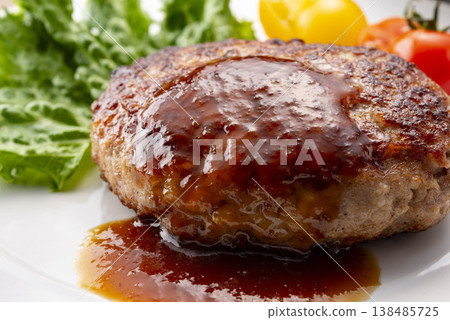 A simple hamburger steak served on a white plate. A homemade-style meat dish on the table. A classic Western dish. A simple hamburger steak served on a white plate. A homemade-style meat dish on the table. A classic Western dish. 138485725