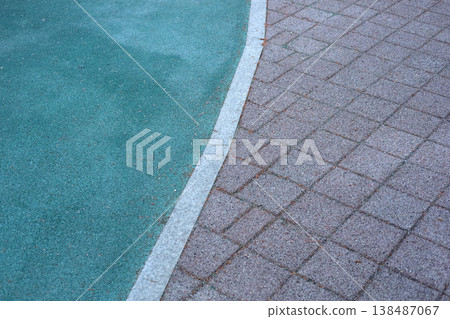Urban pavement with green rubber playground surface curve Urban pavement with green rubber playground surface curve 138487067