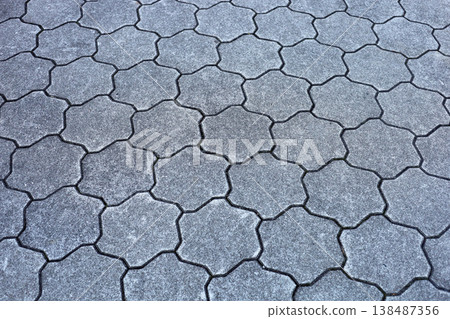 Gray star-shaped stone tiles covering the outdoor walkway. Gray star-shaped stone tiles covering the outdoor walkway. 138487356