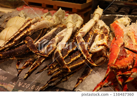 Frozen king crab legs on ice with price tags. Frozen king crab legs on ice with price tags. 138487360