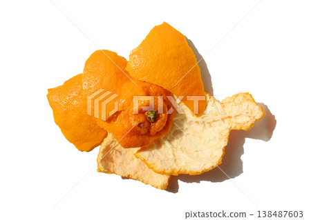 Fresh orange peels on a white surface. Fresh orange peels on a white surface. 138487603