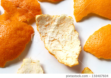 Fresh orange peels on a white surface. 138487604