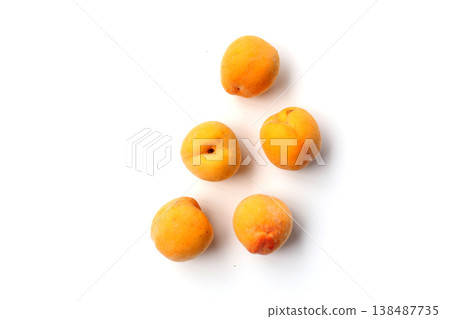 Fresh ripe apricots on a white background. Fresh ripe apricots on a white background. 138487735