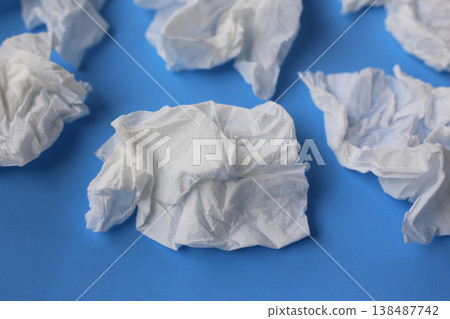 Used crumpled tissues scattered on a blue surface. Used crumpled tissues scattered on a blue surface. 138487742