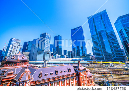 A magnificent view of Tokyo's urban landscape, including the auspicious Doctor Yellow train, Tokyo Station, trains, the buildings of Yaesu, and cherry blossoms. 138487768