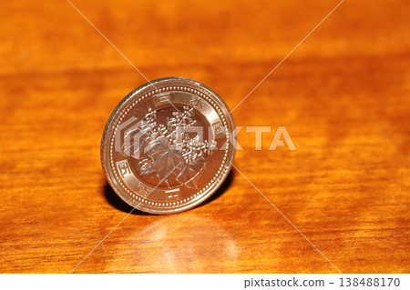Close-up of a 500 yen coin standing upright Close-up of a 500 yen coin standing upright 138488170