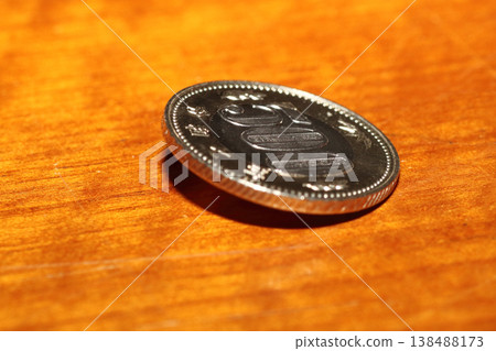 Close-up of a 500 yen coin standing upright Close-up of a 500 yen coin standing upright 138488173