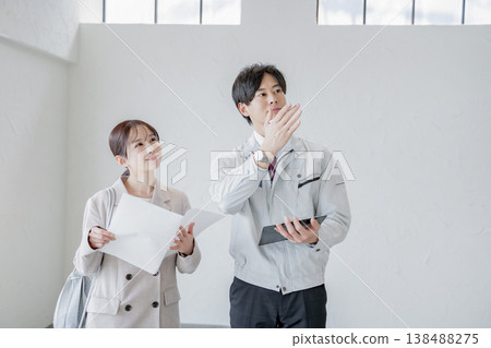 A man in work clothes explaining the property. A man in work clothes explaining the property. 138488275