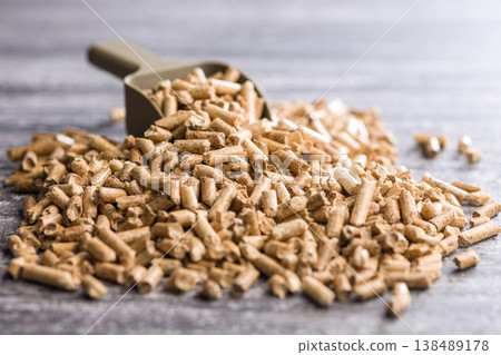Wood Pellets With Metal Scoop On Concrete Surface For Biomass Fuel And Heating Use Wood Pellets With Metal Scoop On Concrete Surface For Biomass Fuel And Heating Use 138489178