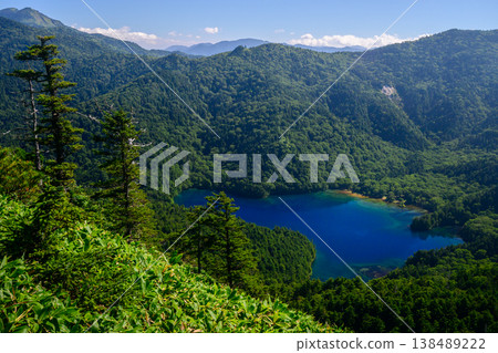 A spectacular view of Lake Onuma from Ura-Shigayama in Shiga Kogen in early autumn (Nagano Prefecture - blue sky and green mountain range) A spectacular view of Lake Onuma from Ura-Shigayama in Shiga Kogen in early autumn (Nagano Prefecture - blue sky and green mountain range) 138489222