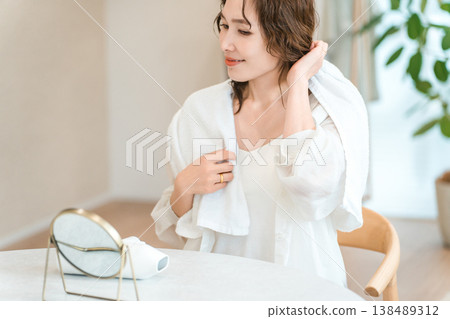 Asian woman towel drying her hair after a bath or shower Asian woman towel drying her hair after a bath or shower 138489312