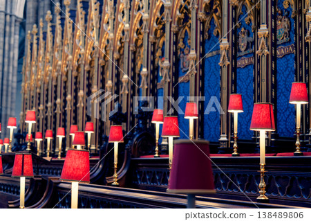 The sacred choir stalls are lined with red candlesticks. The sacred choir stalls are lined with red candlesticks. 138489806