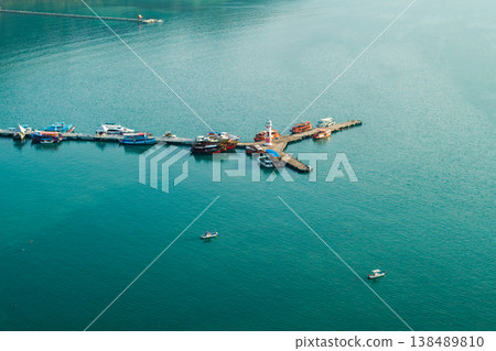High angle aerial view of coral reefs under crystal clear turquoise water in Ko Chang, Thailand. Tropical sea bottom. 138489810
