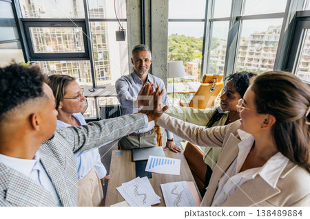 Colleagues of different ethnicities share joyful highfive moments Colleagues of different ethnicities share joyful highfive moments 138489884